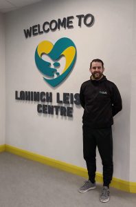 Picture of General Manager Eoin Conlon and written in a sign behind him, Welcome to Lahinch Leisure Centre